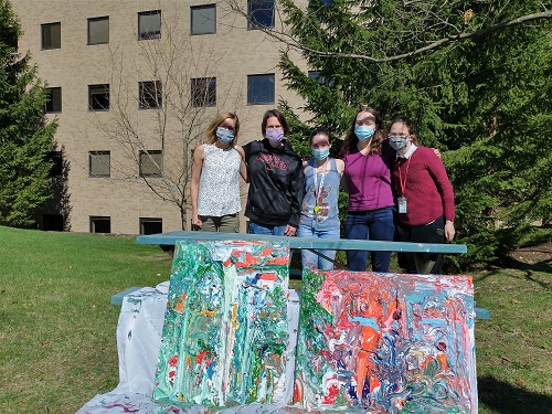 group photo of lab members with their new artwork